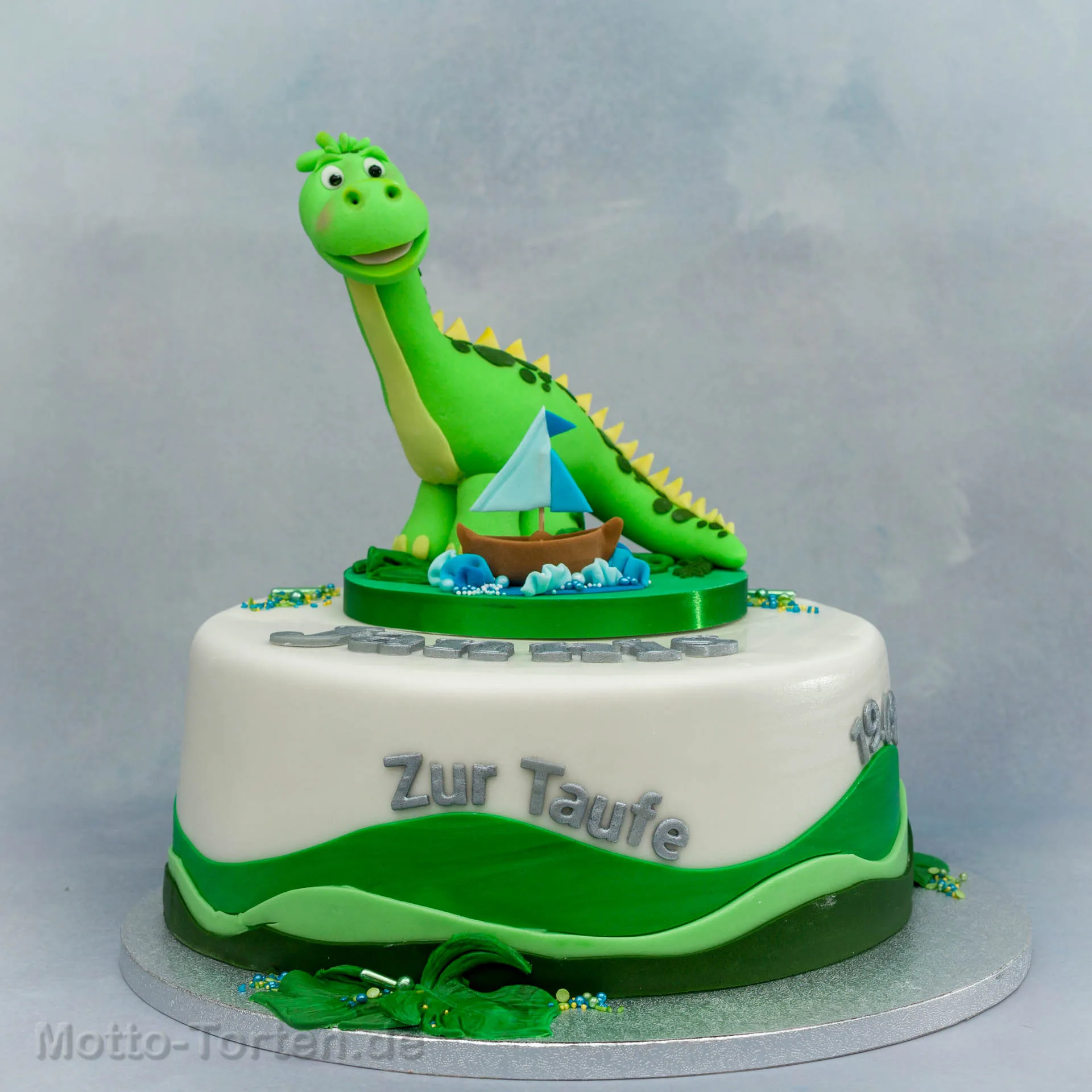 Tauftorte mit modelliertem Dinosaurier